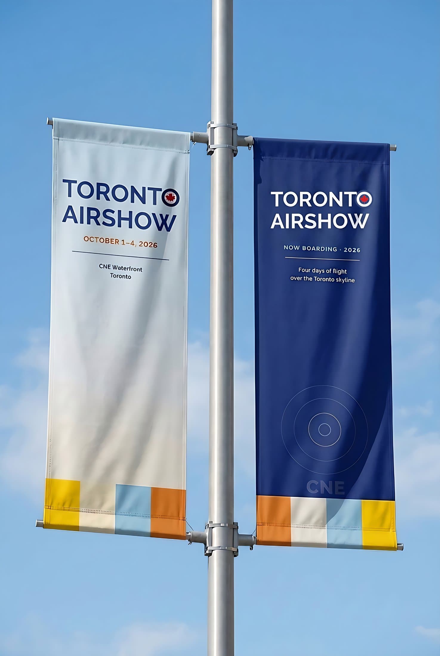 Street pole banners — a vertical pair; the navy banner carries the reversed white wordmark printed on the fabric
